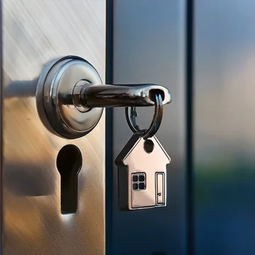 A key with a house keyring in a front door